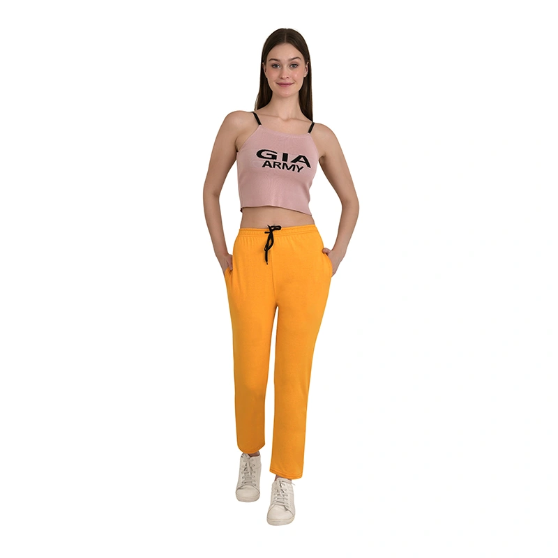 Female model in mustard yellow jogger pants and crop top - western wear ecommerce photography by Lohar Studio Delhi